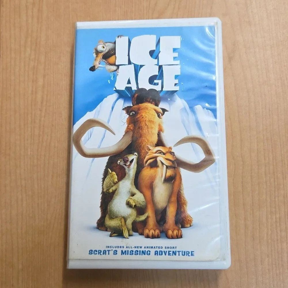 collection of Ice Age merchandise, including a VHS tape, two DVDs, Sid the Sloth